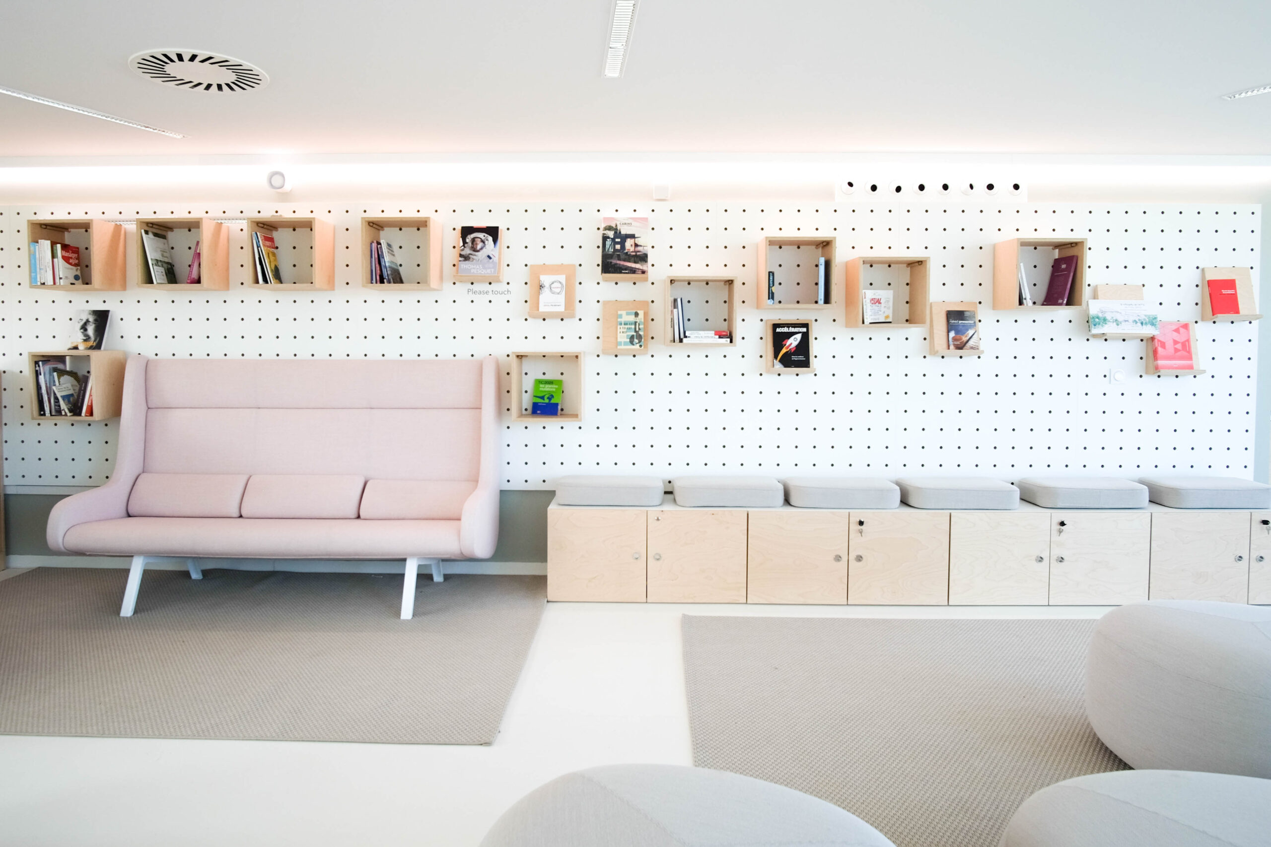 Mobilier en multi-plis de bouleau brut et bakélisé, créant une atmosphère épurée et modulable selon les besoins des visiteurs.